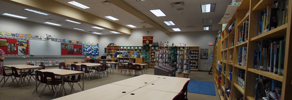 Tables, chairs, books in the Learning Commons area